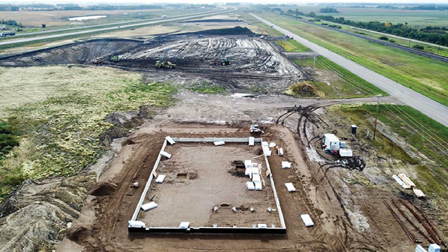 Development east of Moosomin Work continues on the development of several buildings east of Moosomin, in the RM of Moosomin. In the foreground, the new RM shop taking shape, and beyond that, work on the Johnston’s Grain building, with two more sites being developed in the background. Photo by Kevin Weedmark.